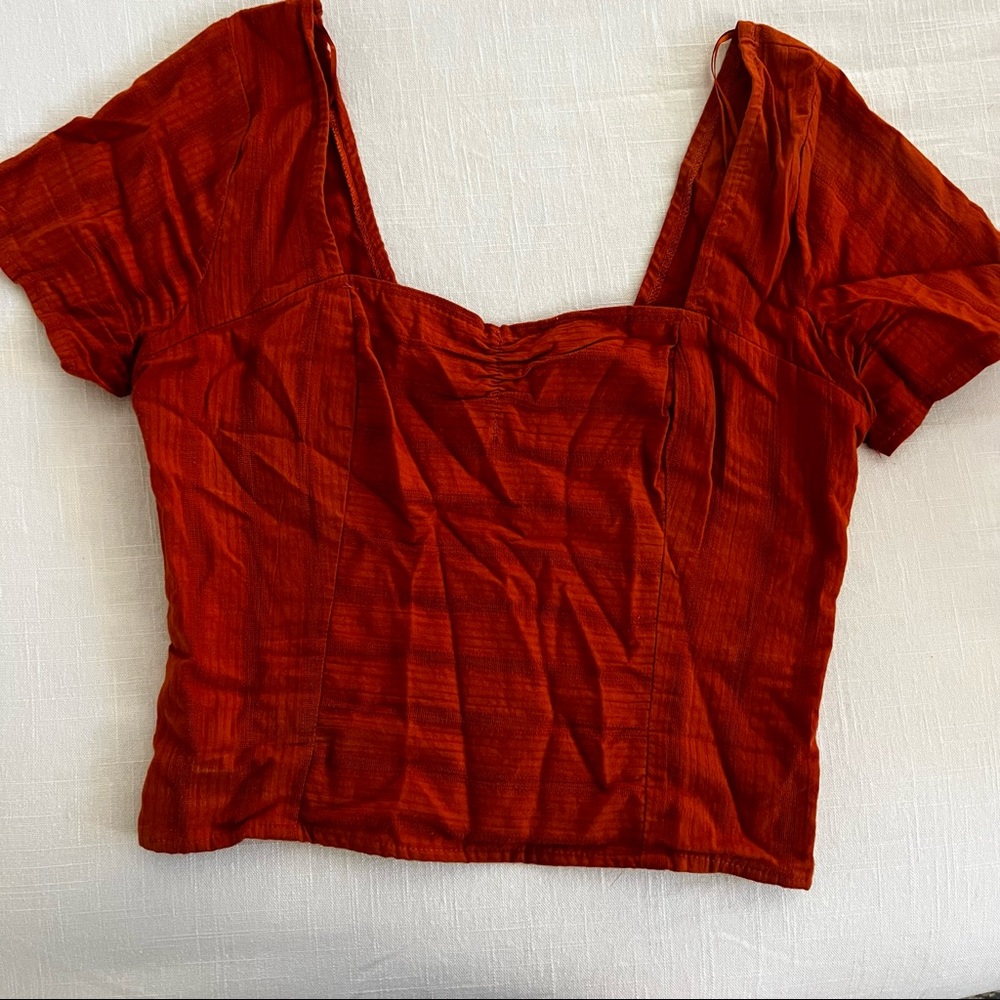 rust colored top.